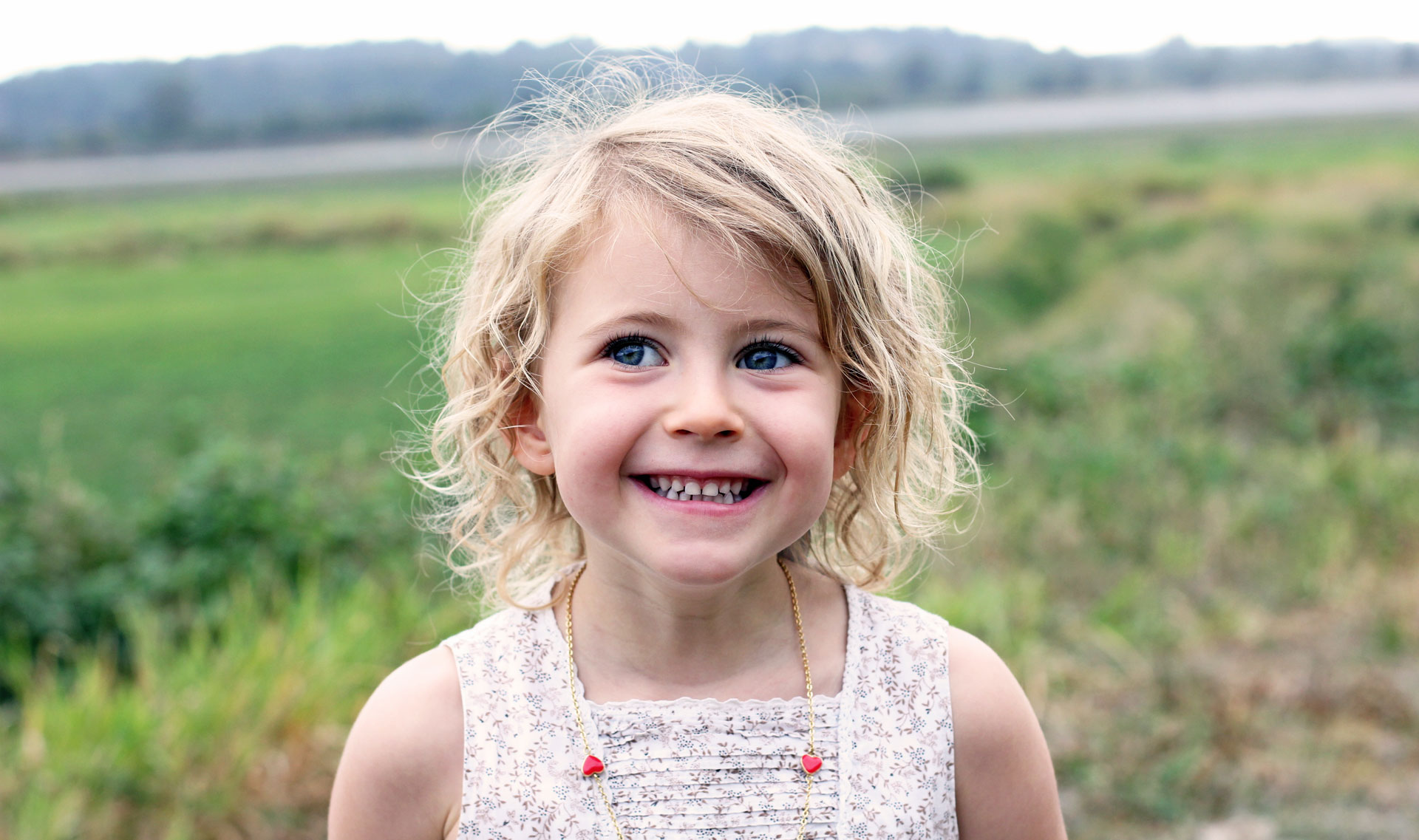 girl in a field smiling